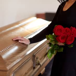 Loved one touching casket