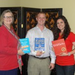 Oliver Law Firm staff showing off their office library books