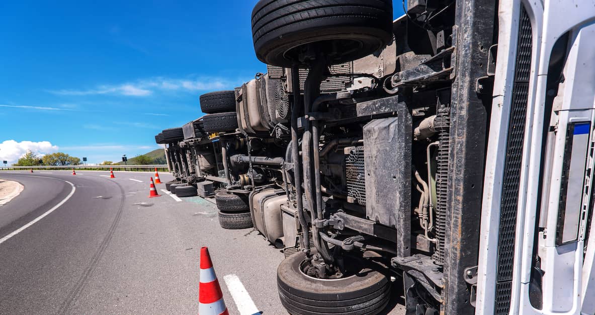 a semi truck lies on its side | Oliver Law Firm