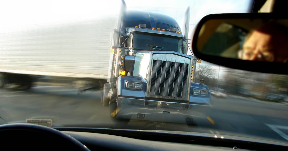 a drivers perspective of a semi truck coming head-on | Oliver Law Firm