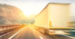 a semi truck drives on a highway | Oliver Law Firm