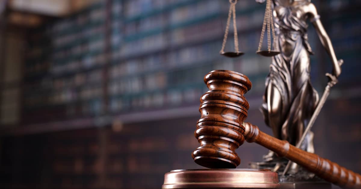 a gavel and scales of justice on a desk | Oliver Law Firm