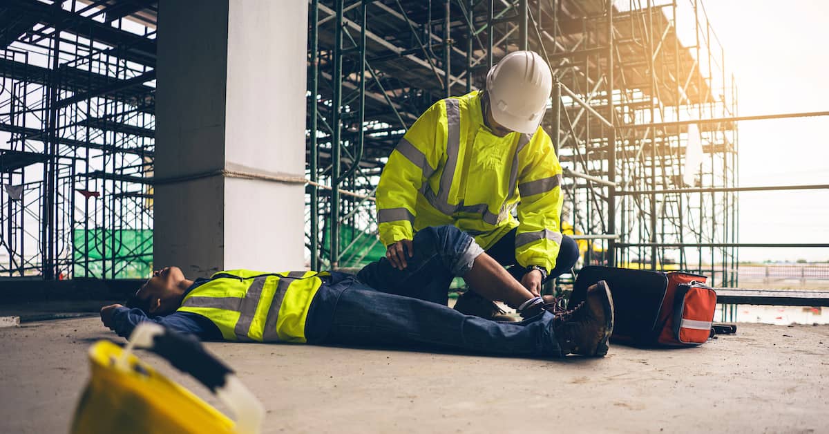 an injured worker gets aid at a construction site