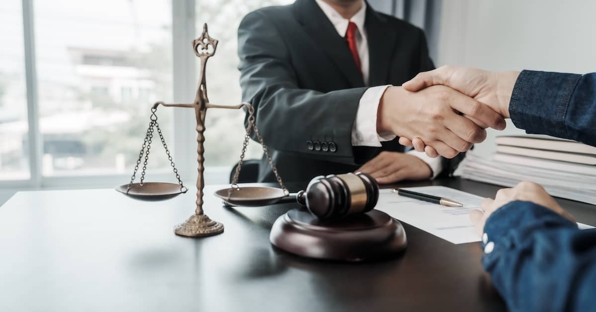 a contingency lawyer shakes a client's hand | Oliver Law Firm